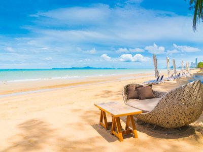 Chair and table dinning on the beach and sea with blue sky background