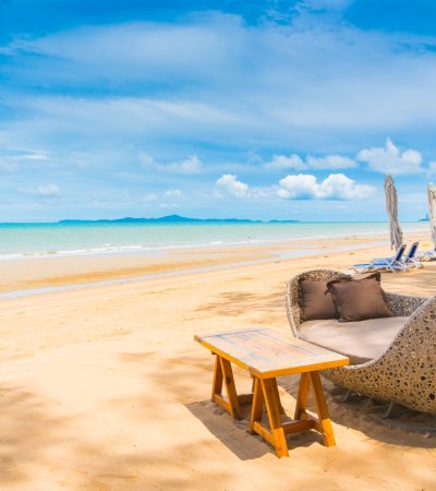 Chair and table dinning on the beach and sea with blue sky background